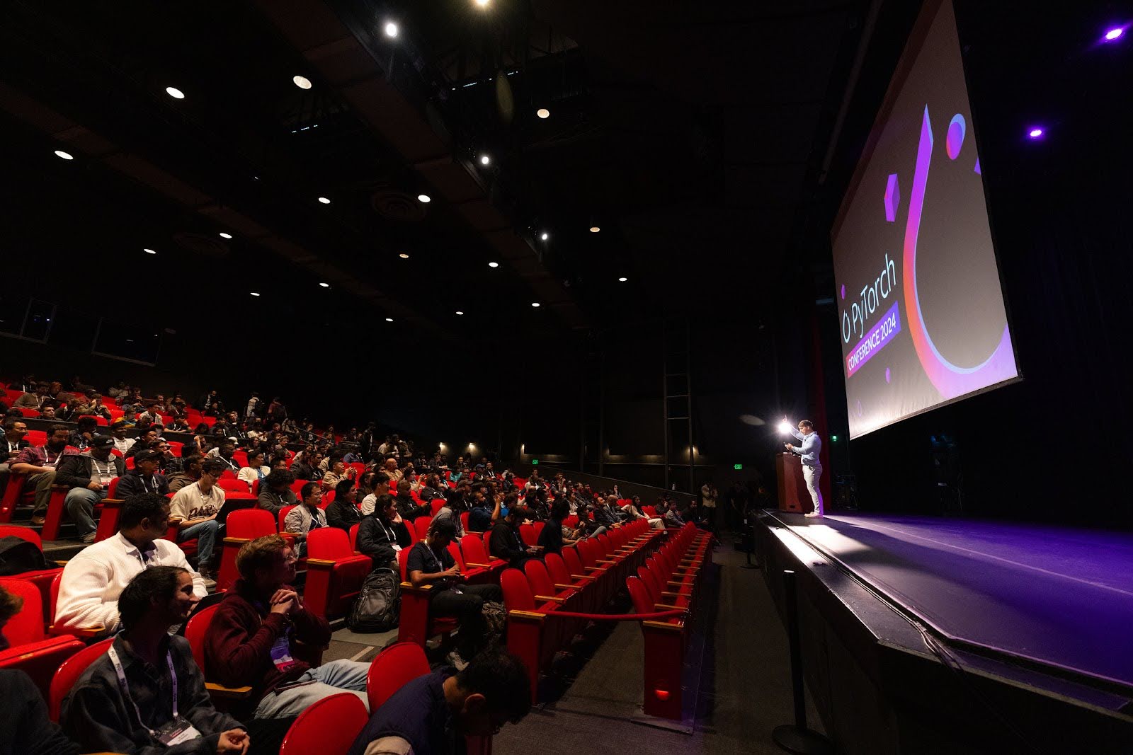 speaking on stage at a conference