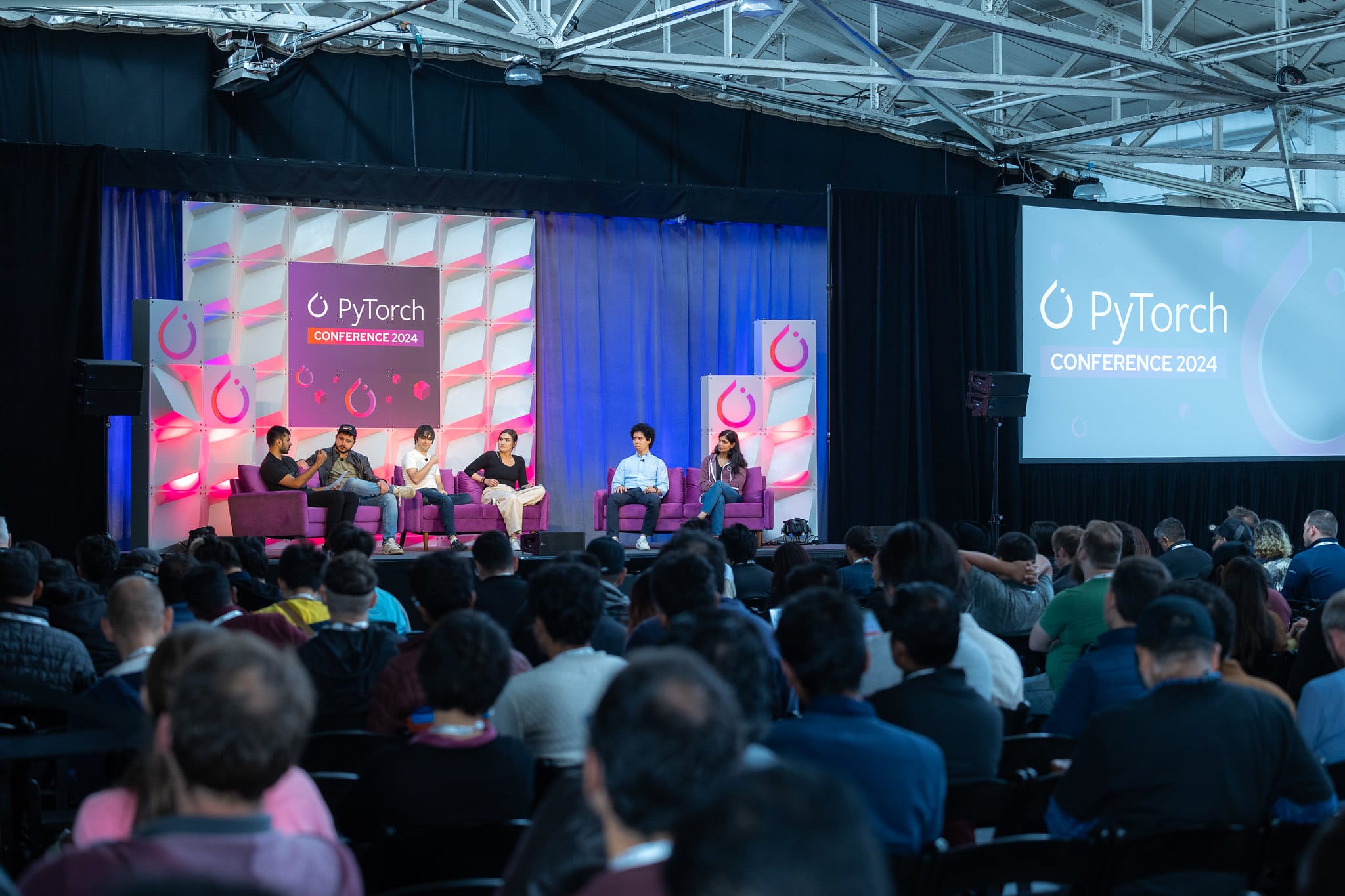 panel of people on a conference stage